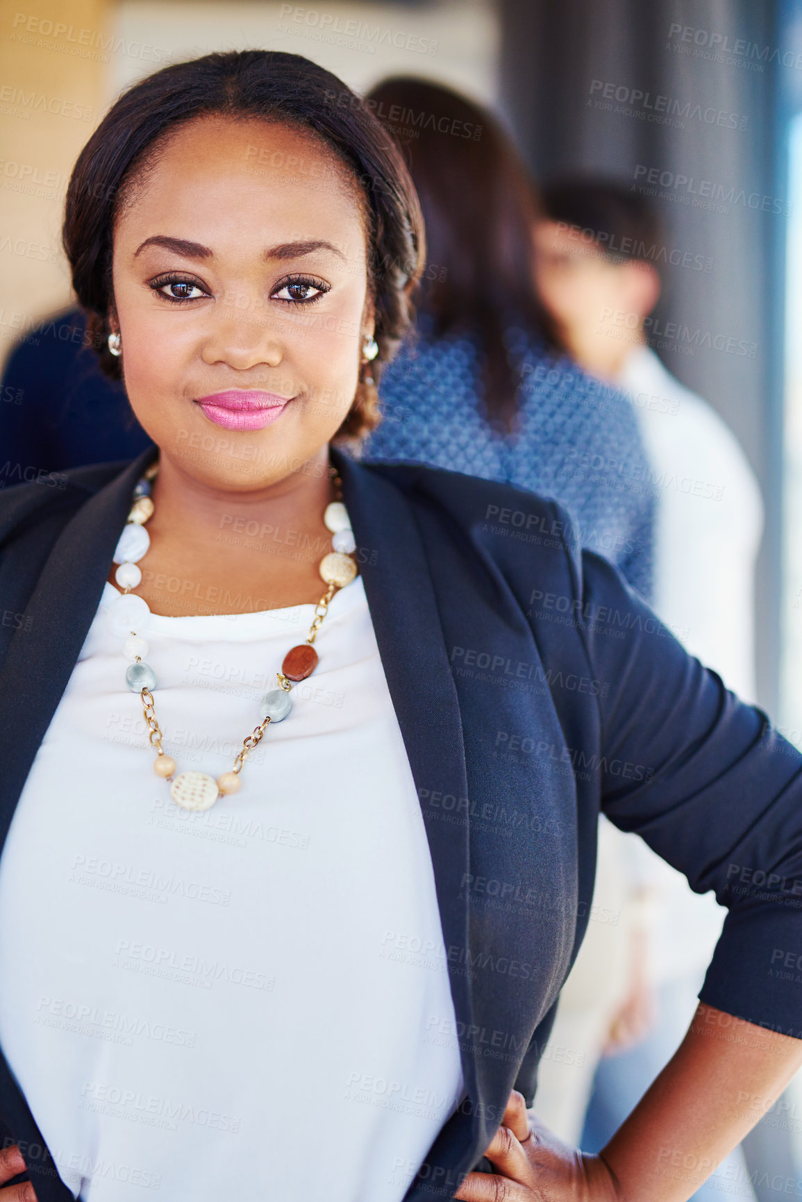 Buy stock photo Cropped portrait of a businesswoman standing in the office with her colleagues in the background