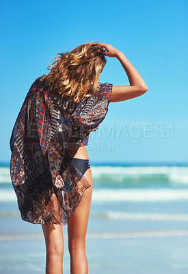 Buy stock photo Rearview shot of a woman looking at the view of the beach