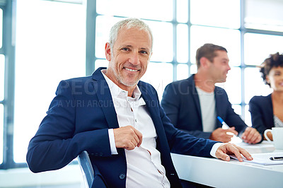 Buy stock photo Cropped portrait of a mature businessman sitting in a meeting