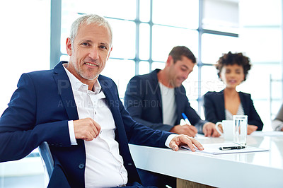 Buy stock photo Cropped portrait of a mature businessman sitting in a meeting