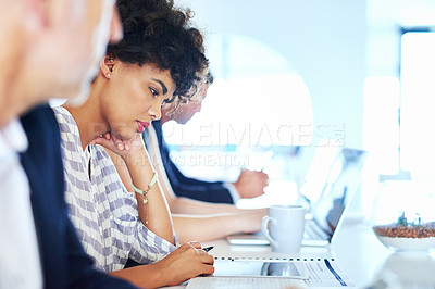 Buy stock photo Shot of colleagues working at a desk in an office