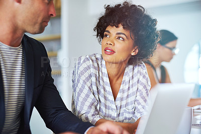 Buy stock photo Shot of coworkers using a laptop together in an office