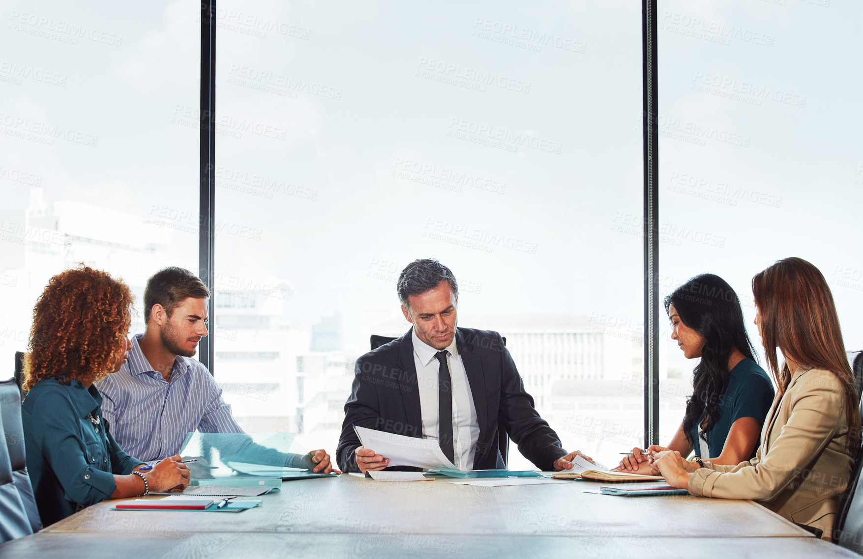 Buy stock photo Shot of a group of businesspeople in a meeting