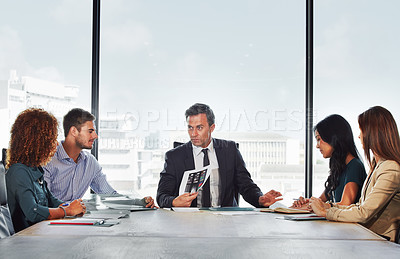 Buy stock photo Shot of a group of businesspeople in a meeting