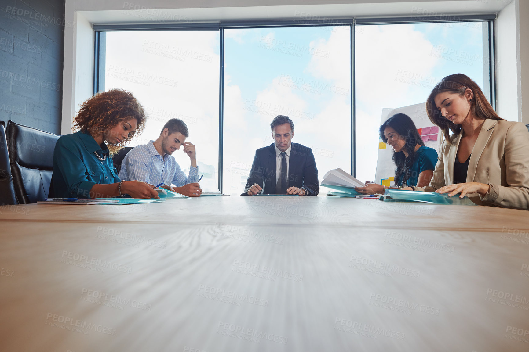 Buy stock photo Shot of a group of businesspeople in a meeting