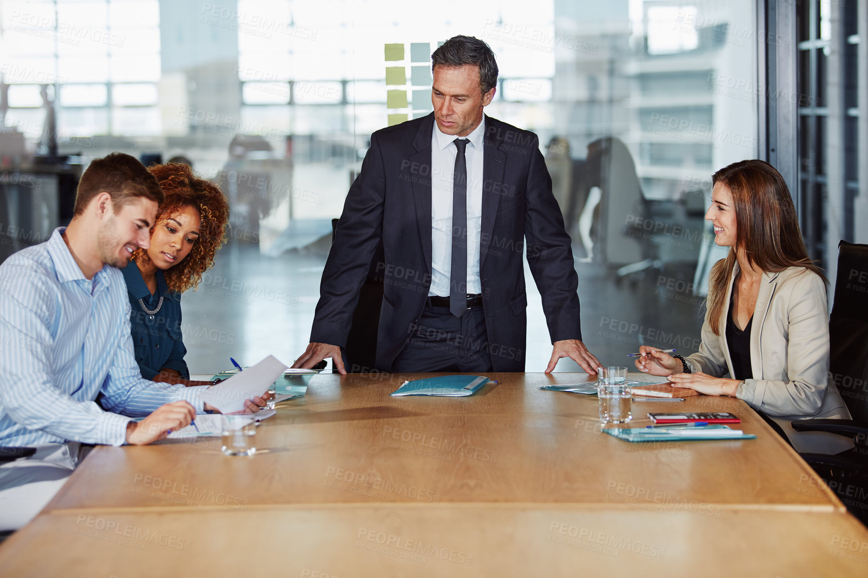 Buy stock photo Shot of a group of businesspeople having a meeting in the boardroom