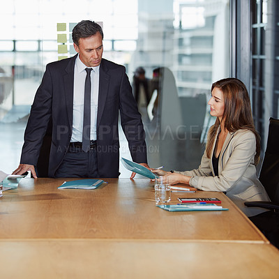 Buy stock photo Shot of two businesspeople having a meeting in the boardroom