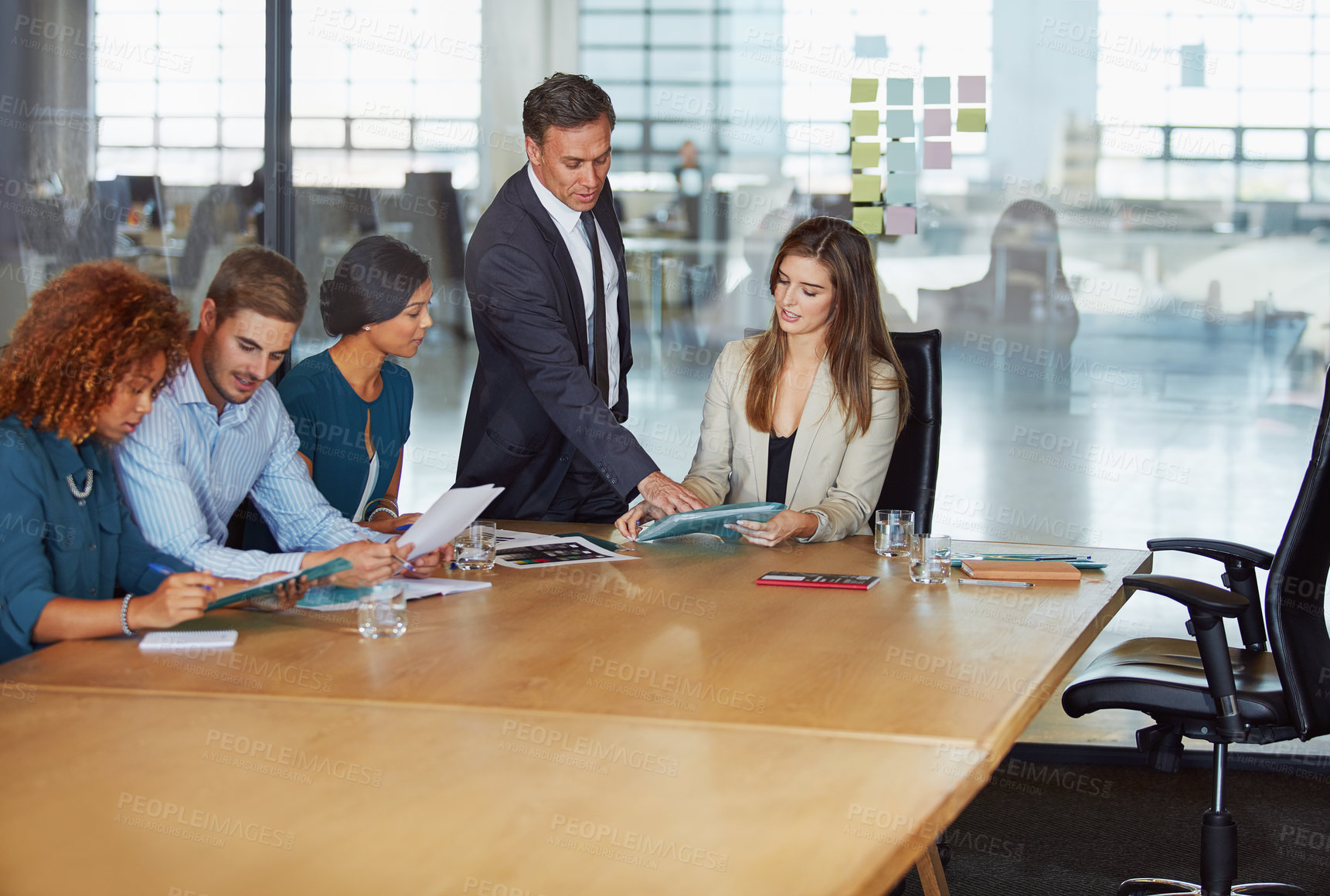 Buy stock photo Shot of a group of businesspeople having a meeting in the boardroom