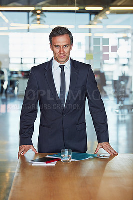 Buy stock photo Portrait of a successful businessman working in an office