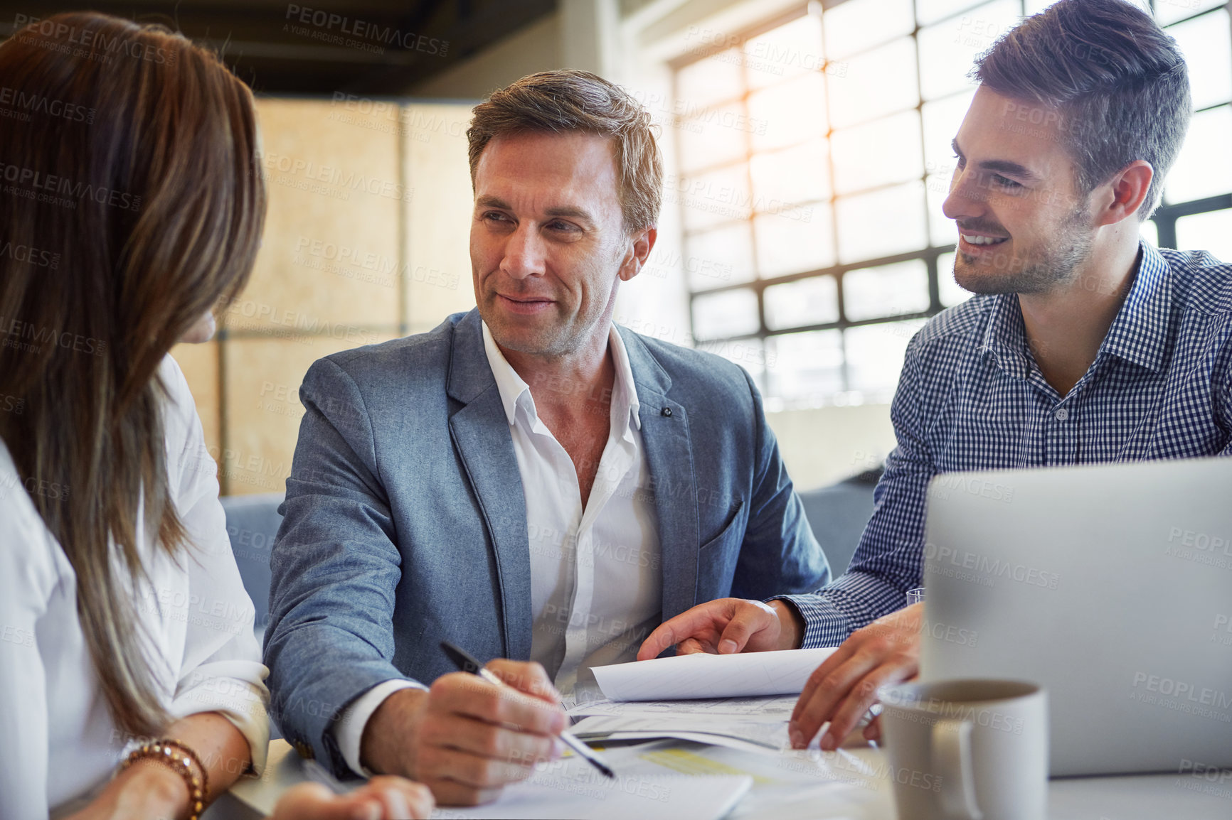 Buy stock photo Cropped shot of three businesspeople working in the office