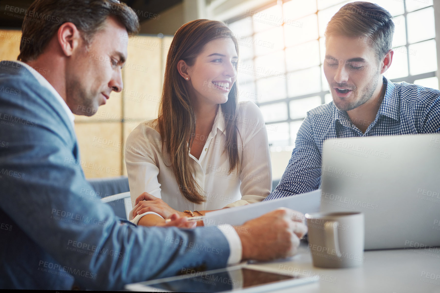 Buy stock photo Cropped shot of three businesspeople working in the office