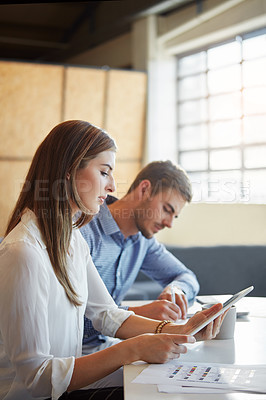 Buy stock photo Cropped shot of two businesspeople working in the office