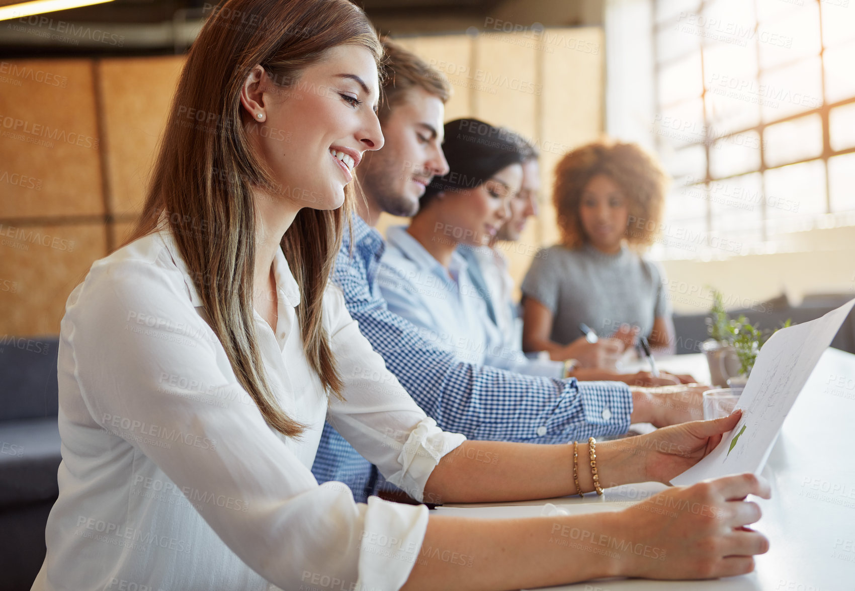 Buy stock photo Cropped shot of a group of businesspeople working in the office