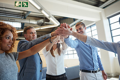Buy stock photo Cropped shot of a group of businesspeople standing in an office huddle