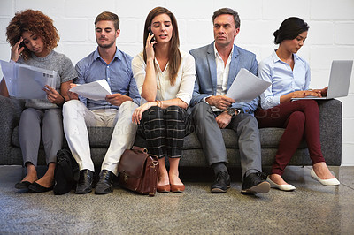 Buy stock photo Full length shot of a group of businesspeople sitting in a line on a sofa