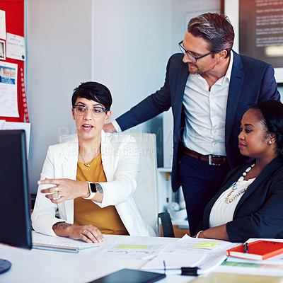 Buy stock photo Cropped shot of three business colleagues working in the office