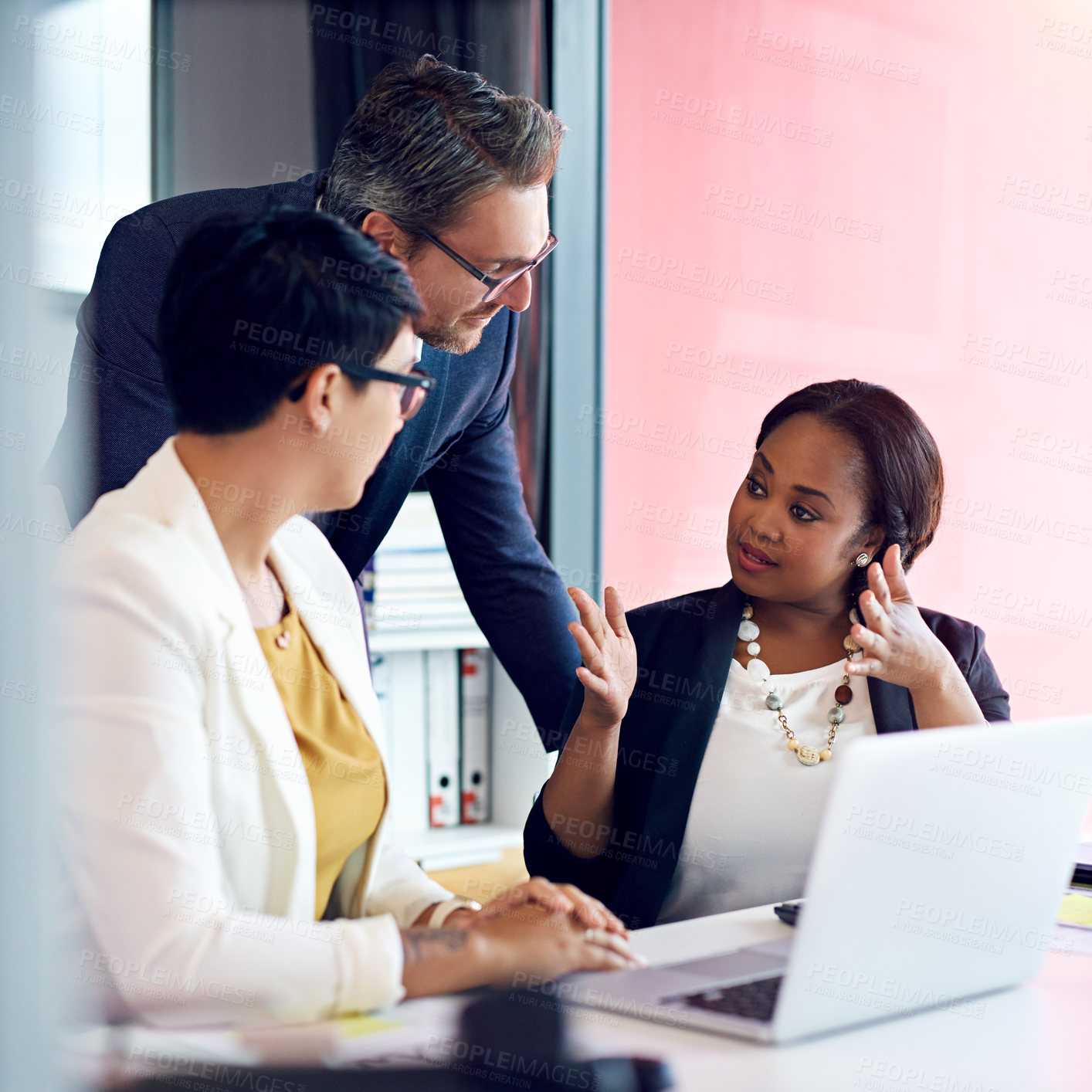 Buy stock photo Cropped shot of three business colleagues working in the office