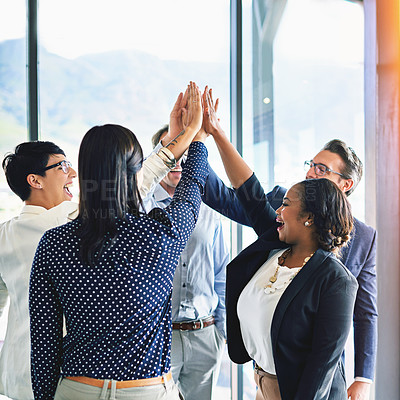 Buy stock photo Cropped shot of a group of coworkers high-fiving in the office