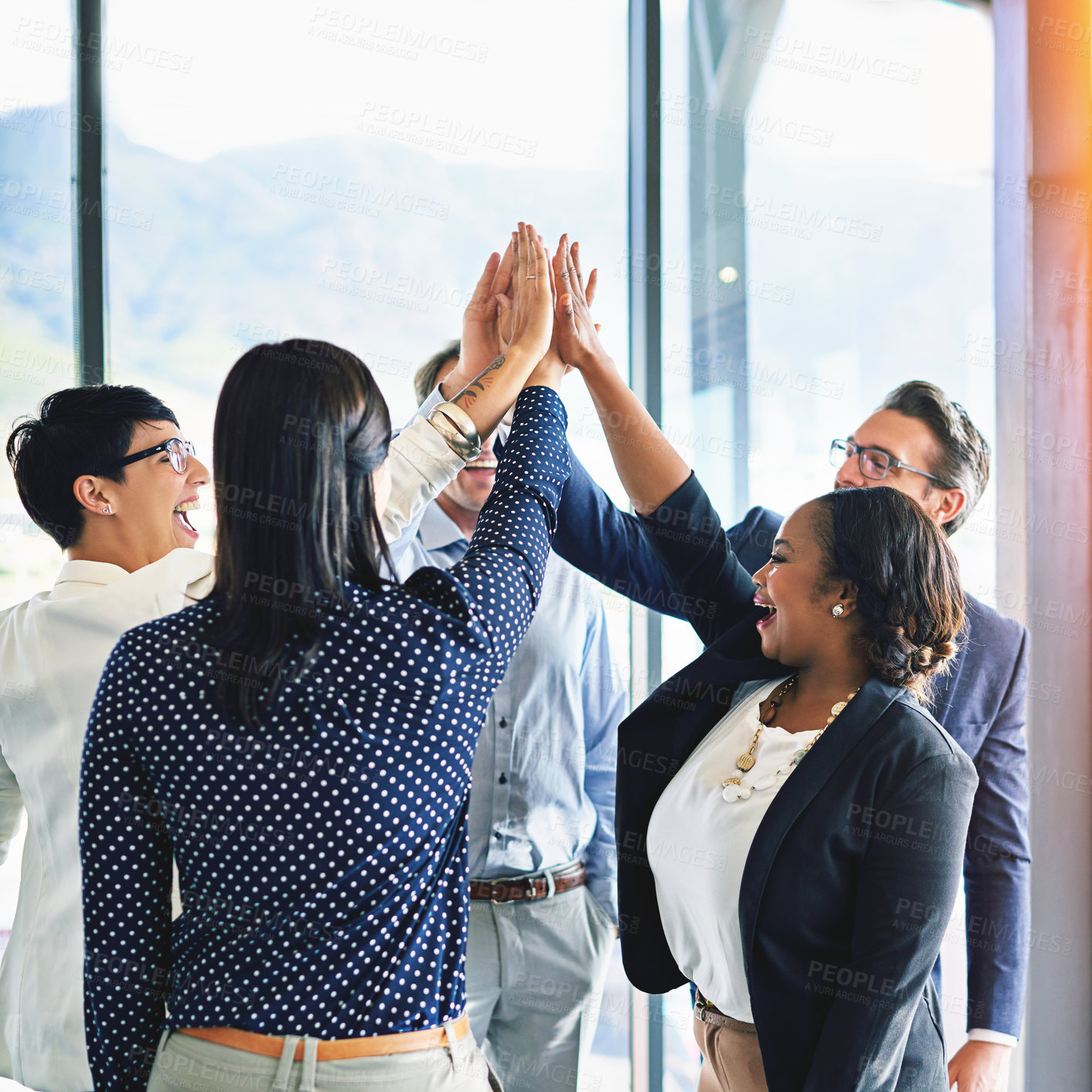 Buy stock photo Cropped shot of a group of coworkers high-fiving in the office
