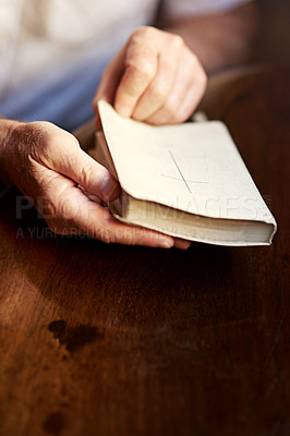 Buy stock photo Cropped shot of a man opening a bible