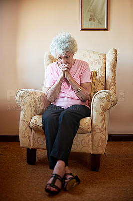 Buy stock photo Shot an elderly woman looking worried