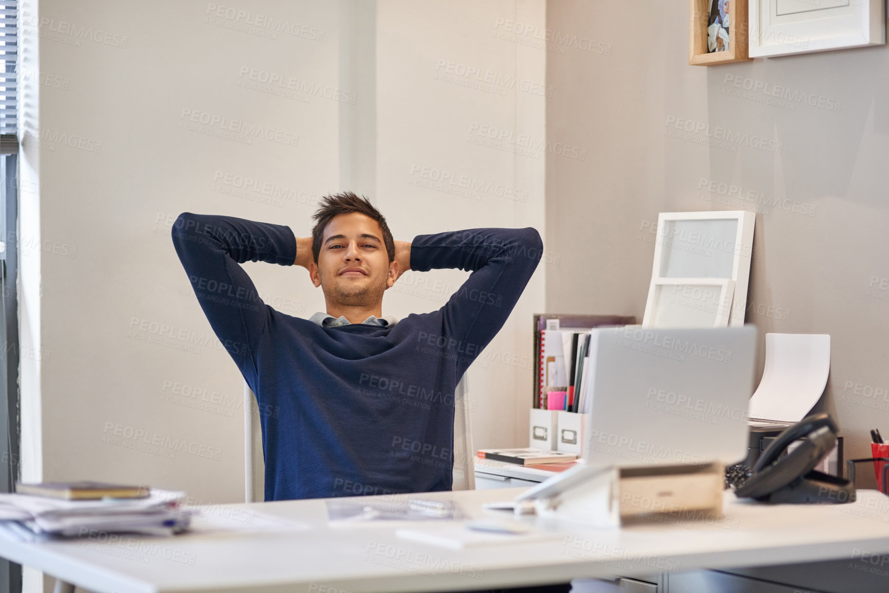 Buy stock photo Portrait of a content businessman sitting at her desk in an office