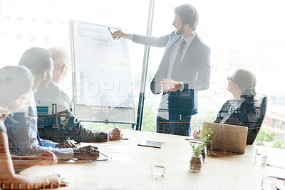 Buy stock photo Multiple exposure shot of colleagues in a presentation superimposed over an industrial background