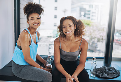 Buy stock photo Cropped portrait of two young women sitting on a bench after yoga class