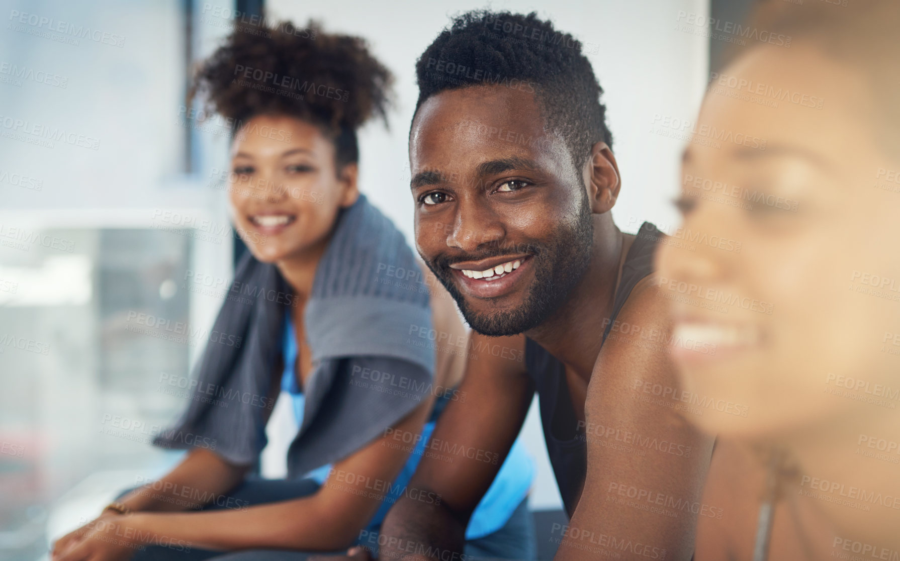 Buy stock photo Cropped shot of three young people sitting in the gym after yoga class