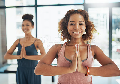 Buy stock photo Shot of two people doing yoga together in a studio