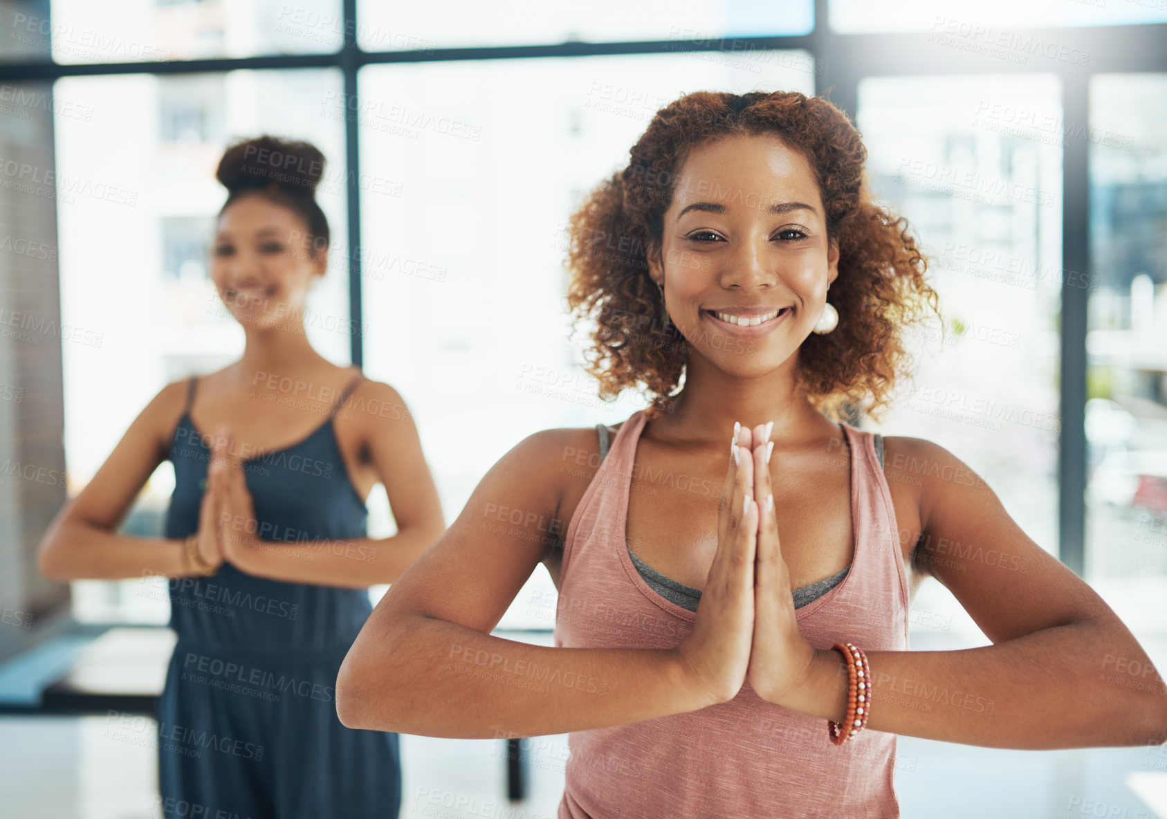 Buy stock photo Shot of two people doing yoga together in a studio