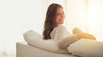 Buy stock photo Shot of a young woman relaxing on her sofa at home