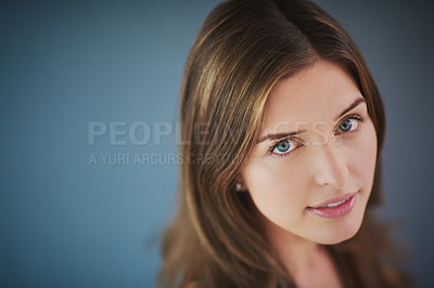 Buy stock photo High angle studio shot of an attractive young woman posing against a gray background
