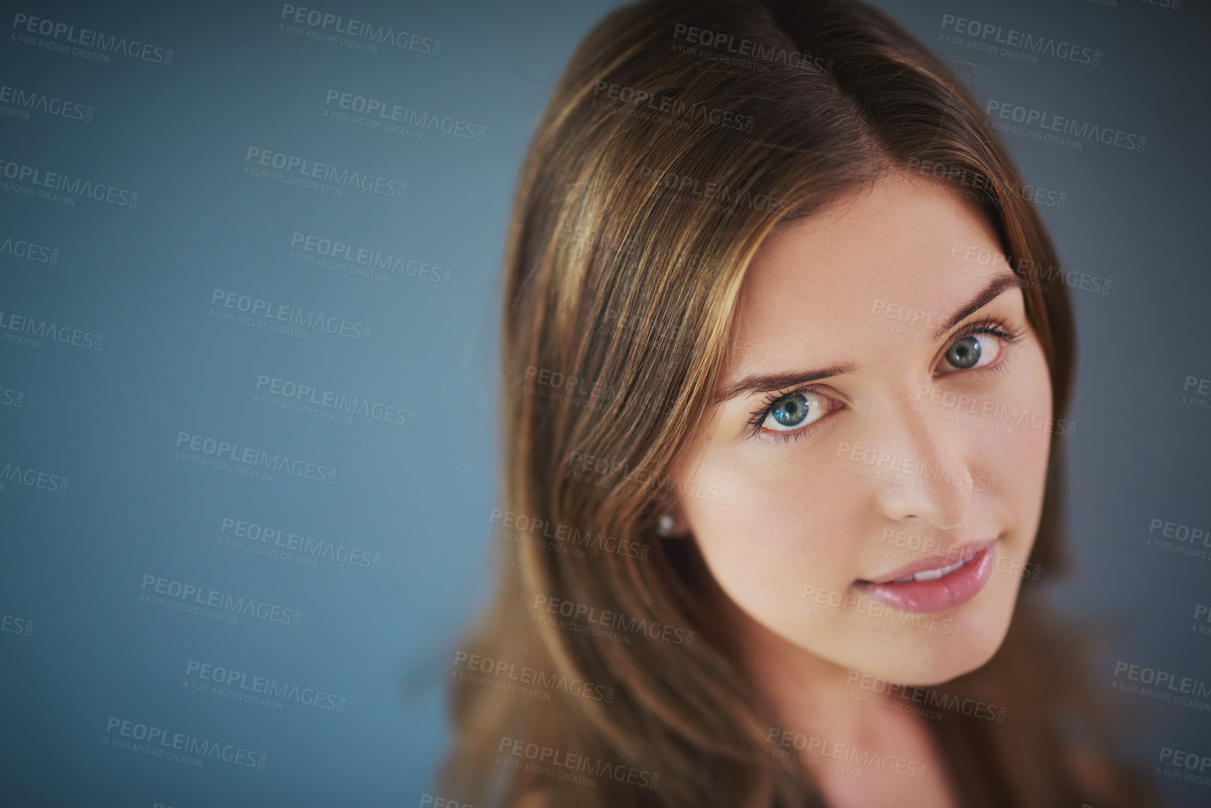 Buy stock photo High angle studio shot of an attractive young woman posing against a gray background