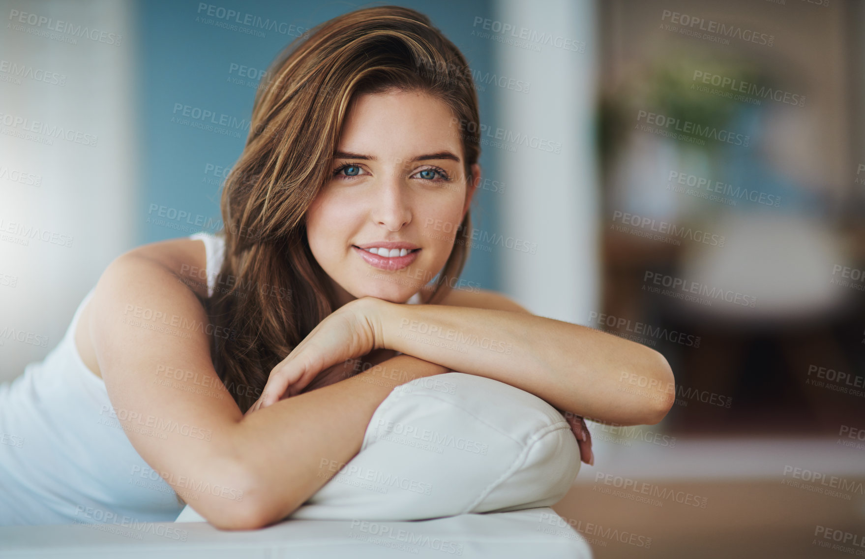 Buy stock photo Woman, home and relax on sofa in portrait with smile on break and chill in Spain. Female person, house and resting with happiness in confidence on couch in living room at apartment on day off