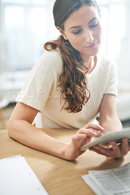 Buy stock photo Shot of a young businesswoman using a digital tablet