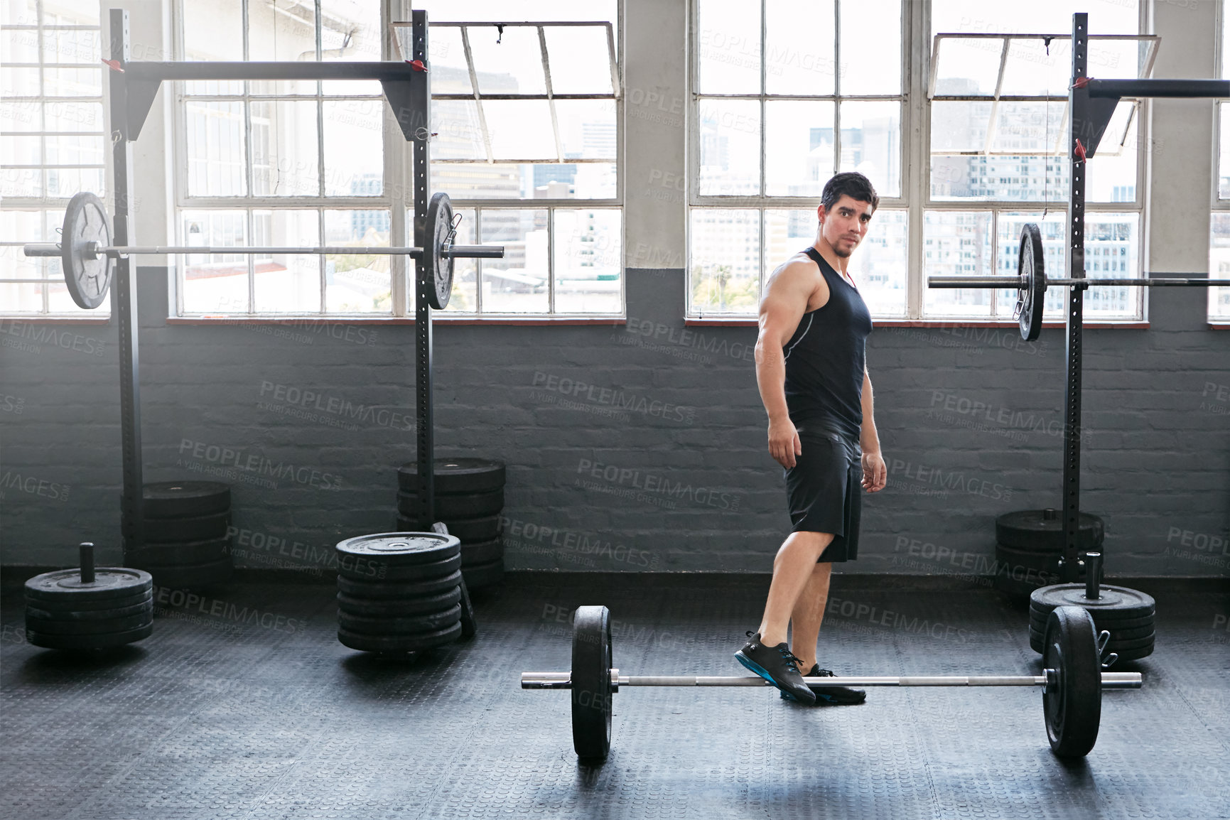 Buy stock photo Shot of a young man working out with weights in the gym