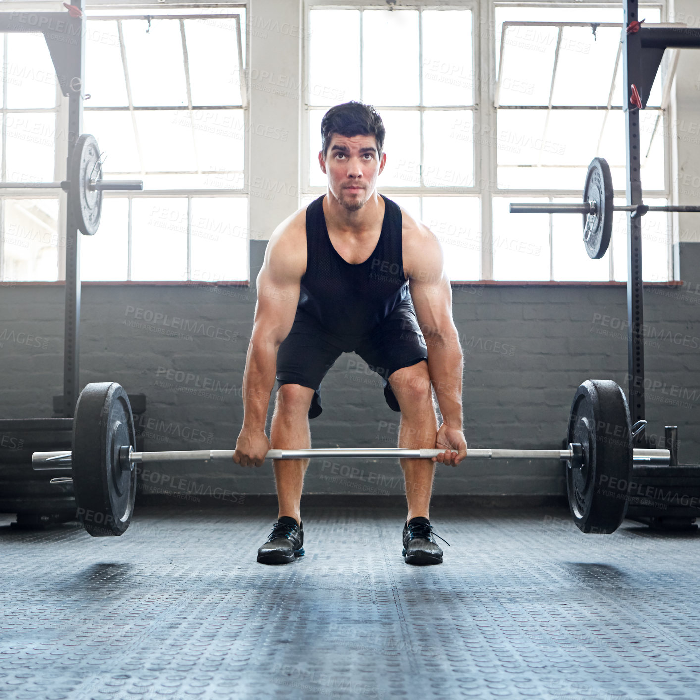 Buy stock photo Shot of a young man working out with weights in the gym