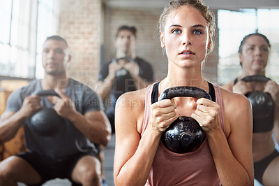 Buy stock photo Fitness, exercise and woman with kettlebell in a gym for a strength training challenge. Sports, energy and female athlete doing a workout with weights with her friends or community in wellness center