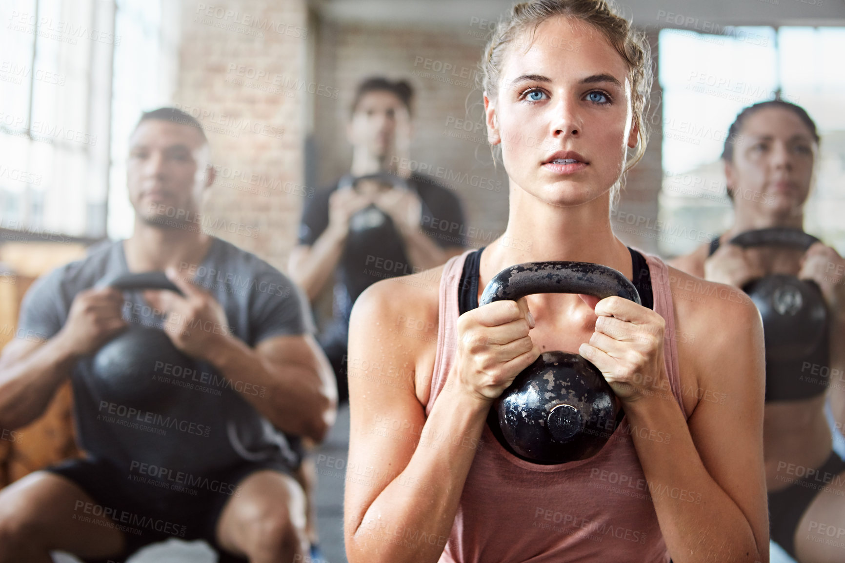 Buy stock photo Fitness, exercise and woman with kettlebell in a gym for a strength training challenge. Sports, energy and female athlete doing a workout with weights with her friends or community in wellness center