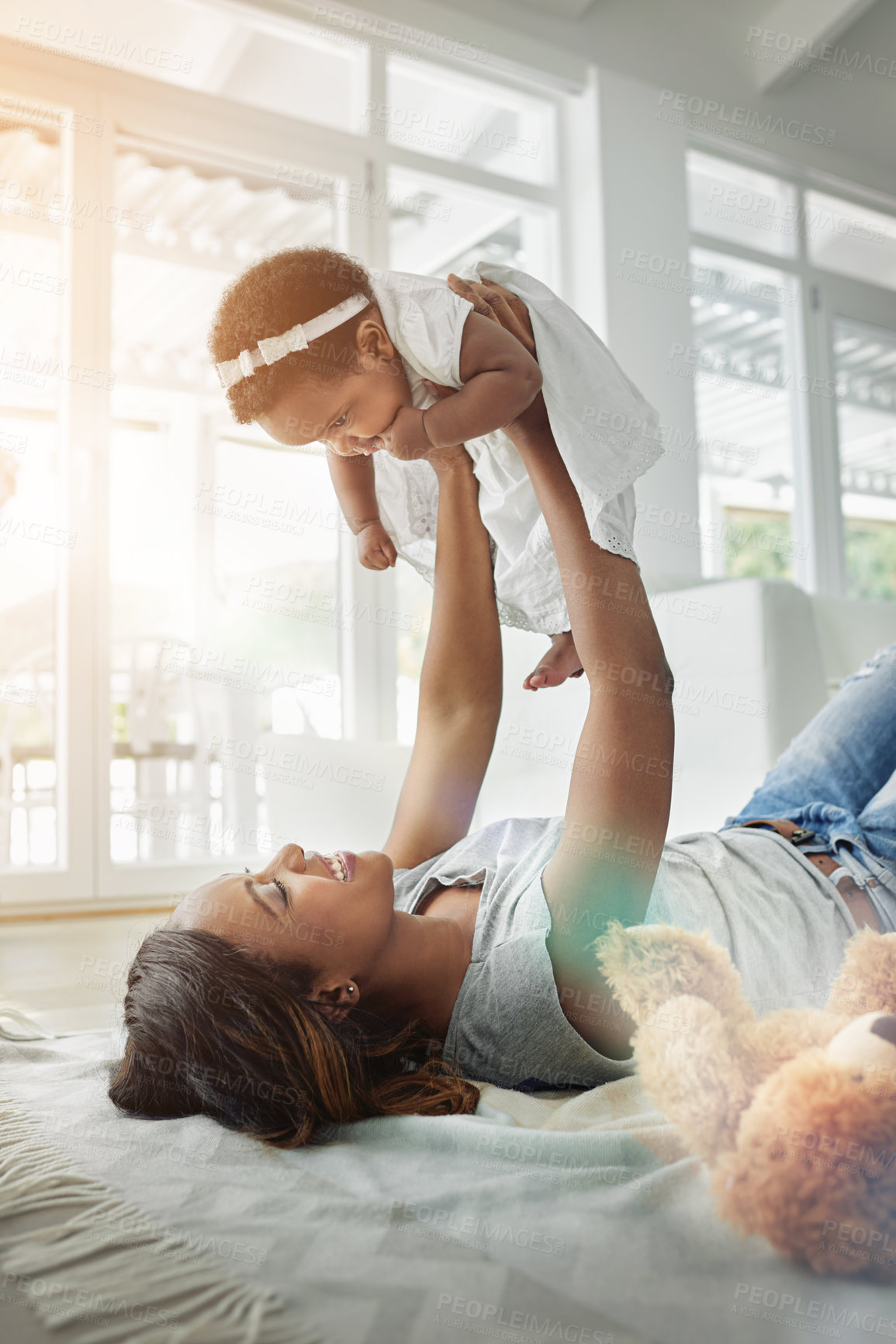 Buy stock photo Happy black woman, baby and playing on floor with love, teddy bear and smile together in living room. Happiness, mother and daughter in flying bonding, quality time for parent and newborn in home.