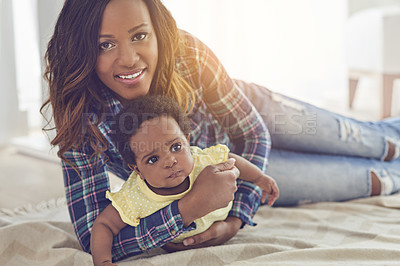 Buy stock photo Cropped shot of a young mother and her little baby girl at home