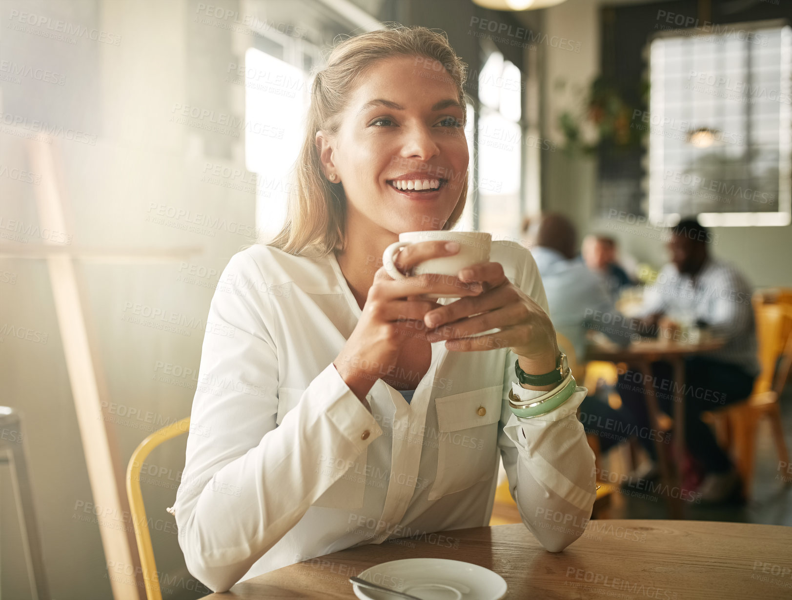 Buy stock photo Shot of an attractive young woman in a coffee shop