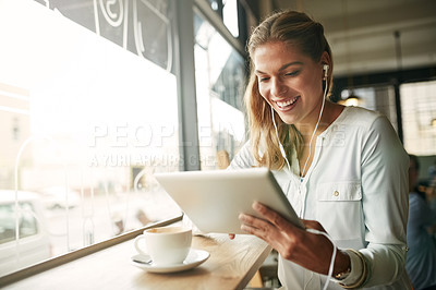 Buy stock photo Shot of an attractive young woman in a coffee shop