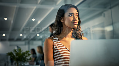 Buy stock photo Shot of a businesswoman using a laptop during a late shift at work