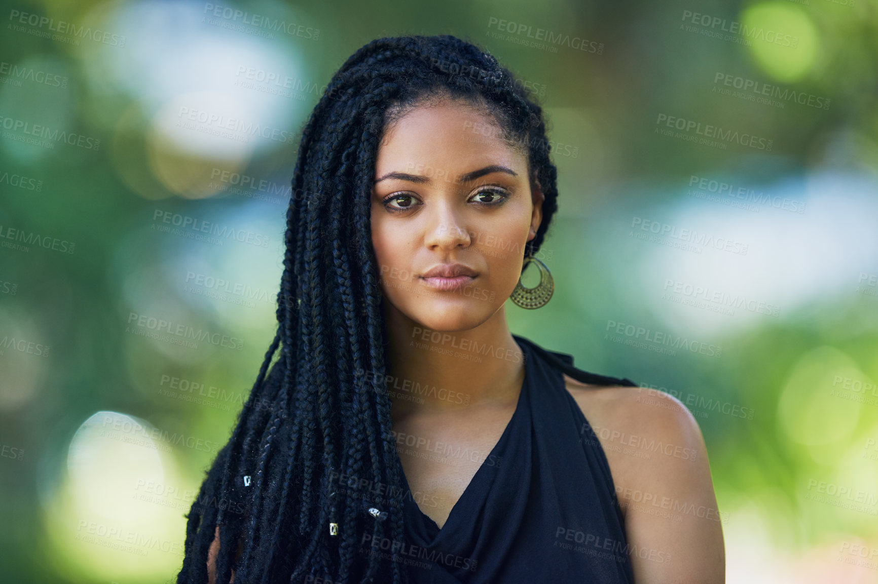 Buy stock photo Portrait of an attractive young woman posing outdoors