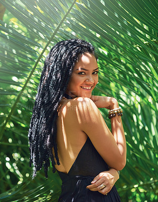 Buy stock photo Portrait of an attractive young woman posing against a leafy background