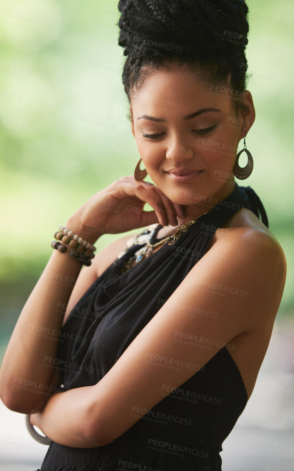 Buy stock photo Shot of an attractive young woman posing outdoors