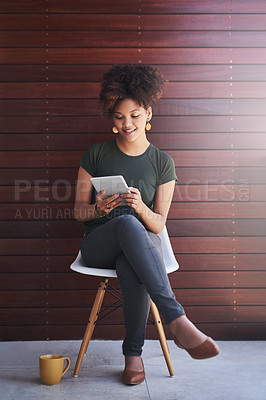 Buy stock photo Shot of a young designer sitting against a wooden background