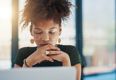 Buy stock photo Shot of a young businesswoman sitting at her desk